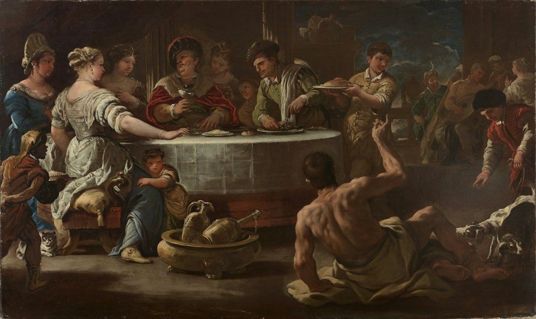 Baroque banquet scene using dramatic chiaroscuro lighting and crowded figures